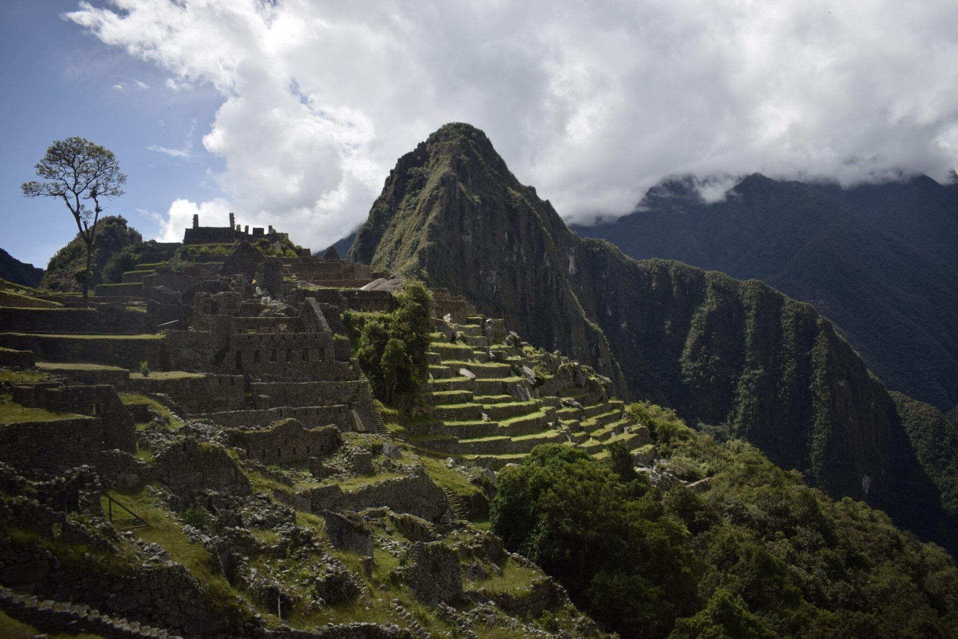 Breathtaking aerial shot of Machu Picchu in Peru, showcasing ancient Incan ruins and lush green mountains.
