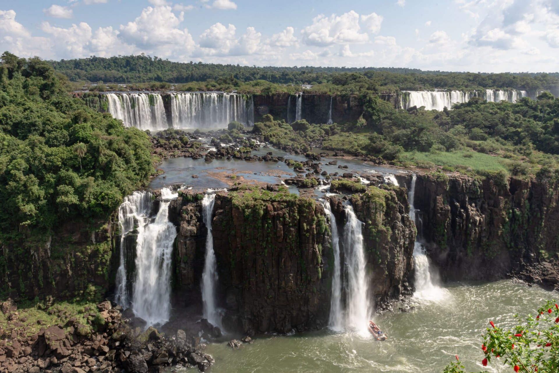 Scenic view of the breathtaking Iguazu Falls cascading amidst lush tropical greenery.
