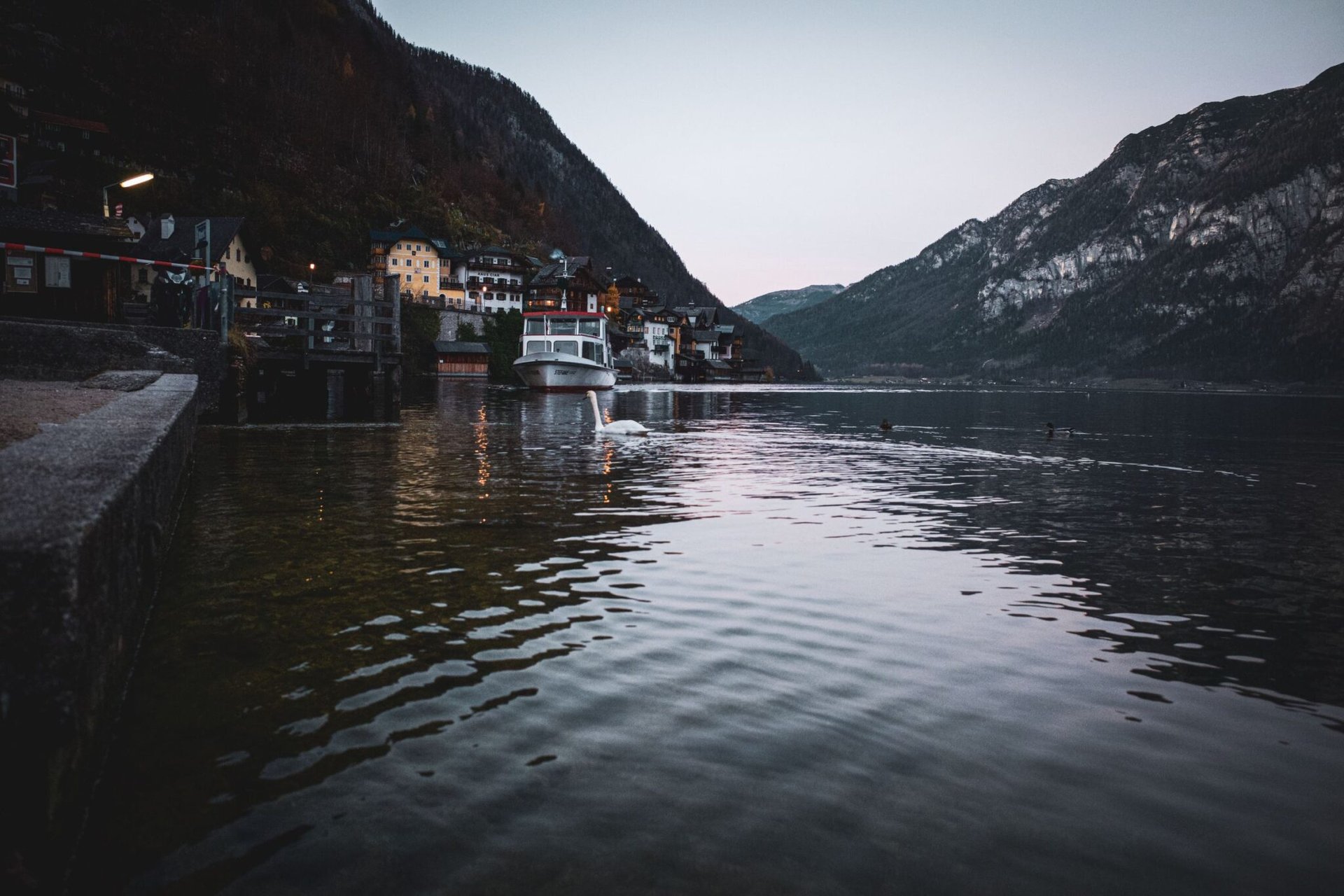 Tranquil evening scene of Hallstatt Lake with village backdrop in Austria.