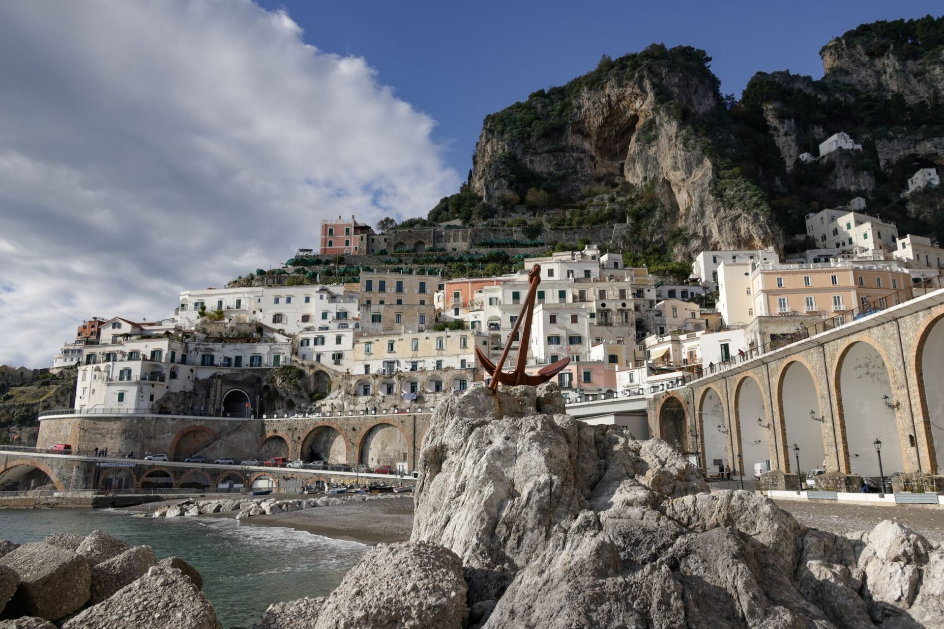 Scenic view of Amalfi, Italy showcasing its historic Mediterranean architecture by the sea.