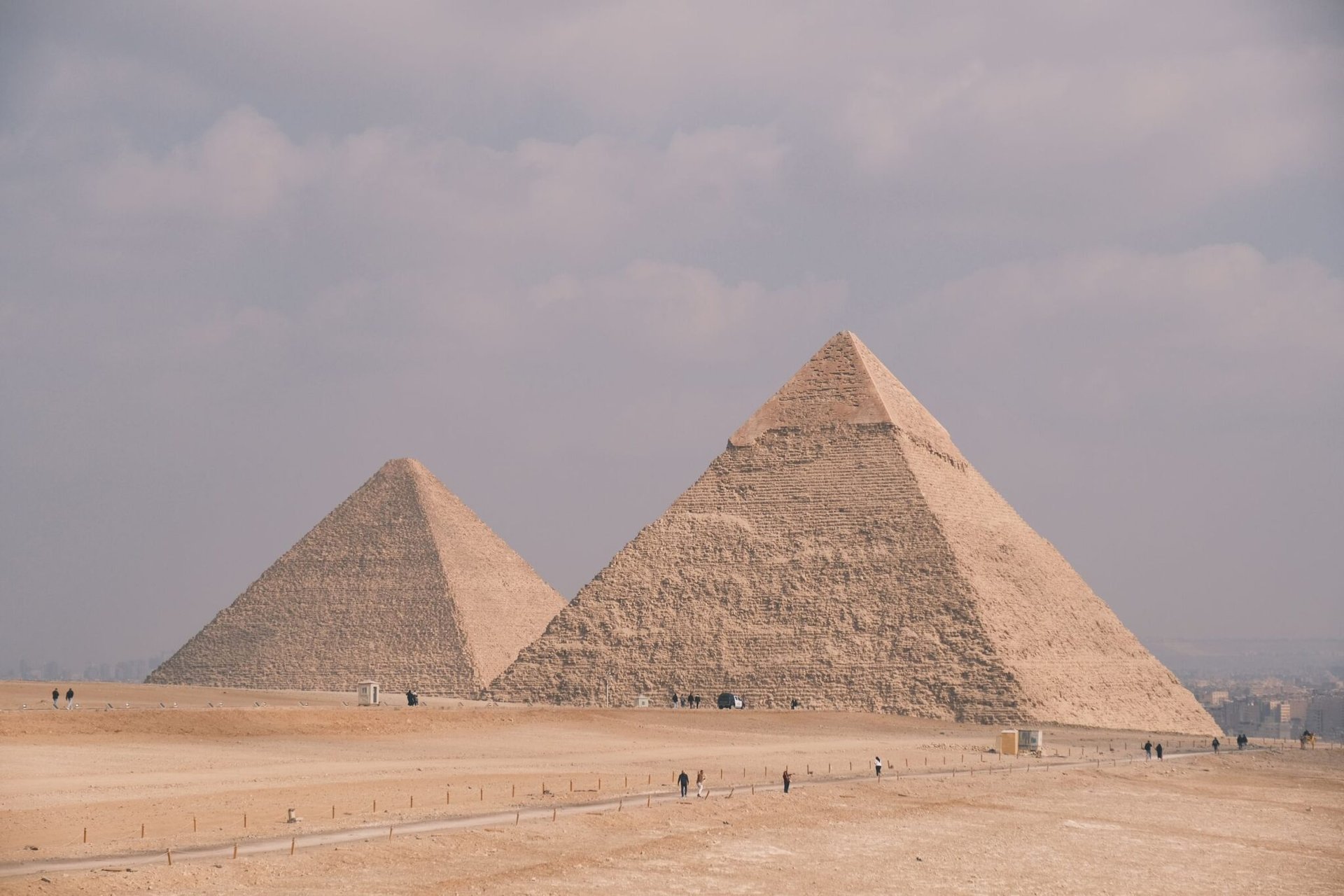 Stunning photo of the Great Pyramids of Giza under a cloudy sky, showcasing Egypt's ancient architecture.