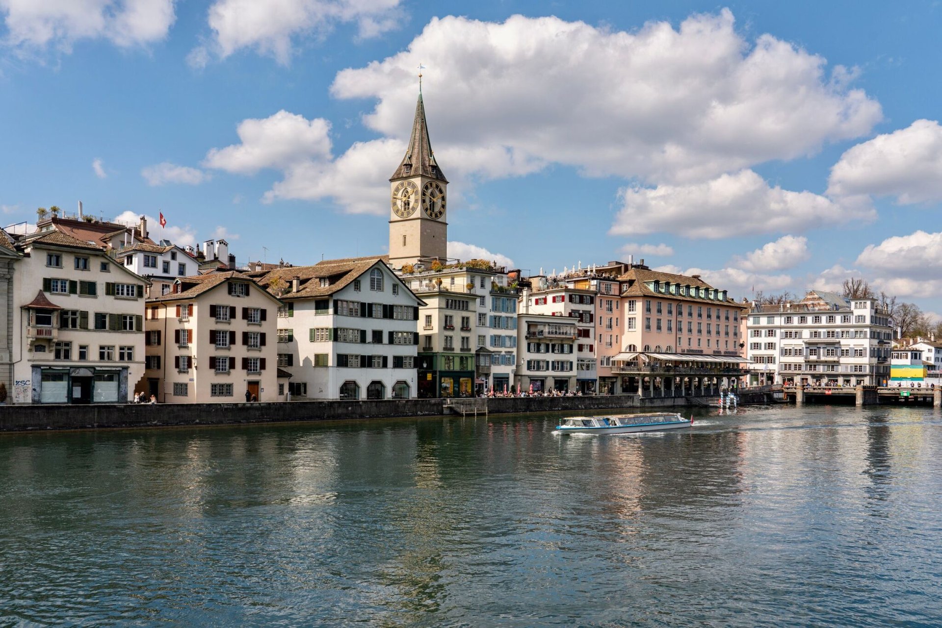 Scenic view of St. Peter's Church by the Limmat River in Zurich, Switzerland.