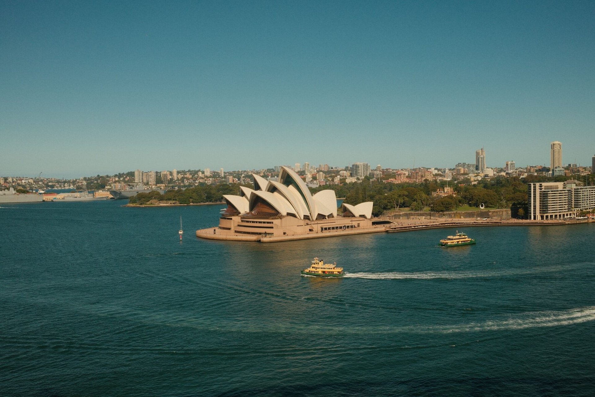Aerial view of Sydney Opera House with ferries in Sydney Harbour, Australia.