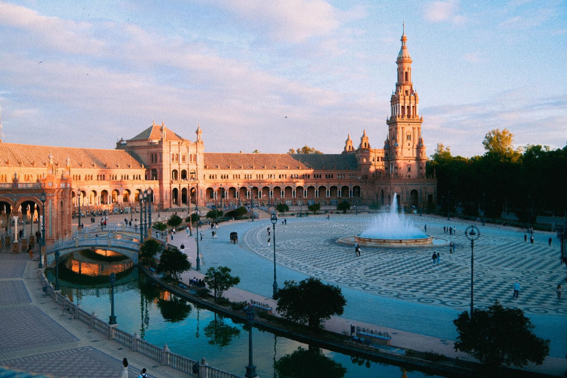 Scenic view of Plaza de España, Seville, Spain illuminated by warm sunset light.