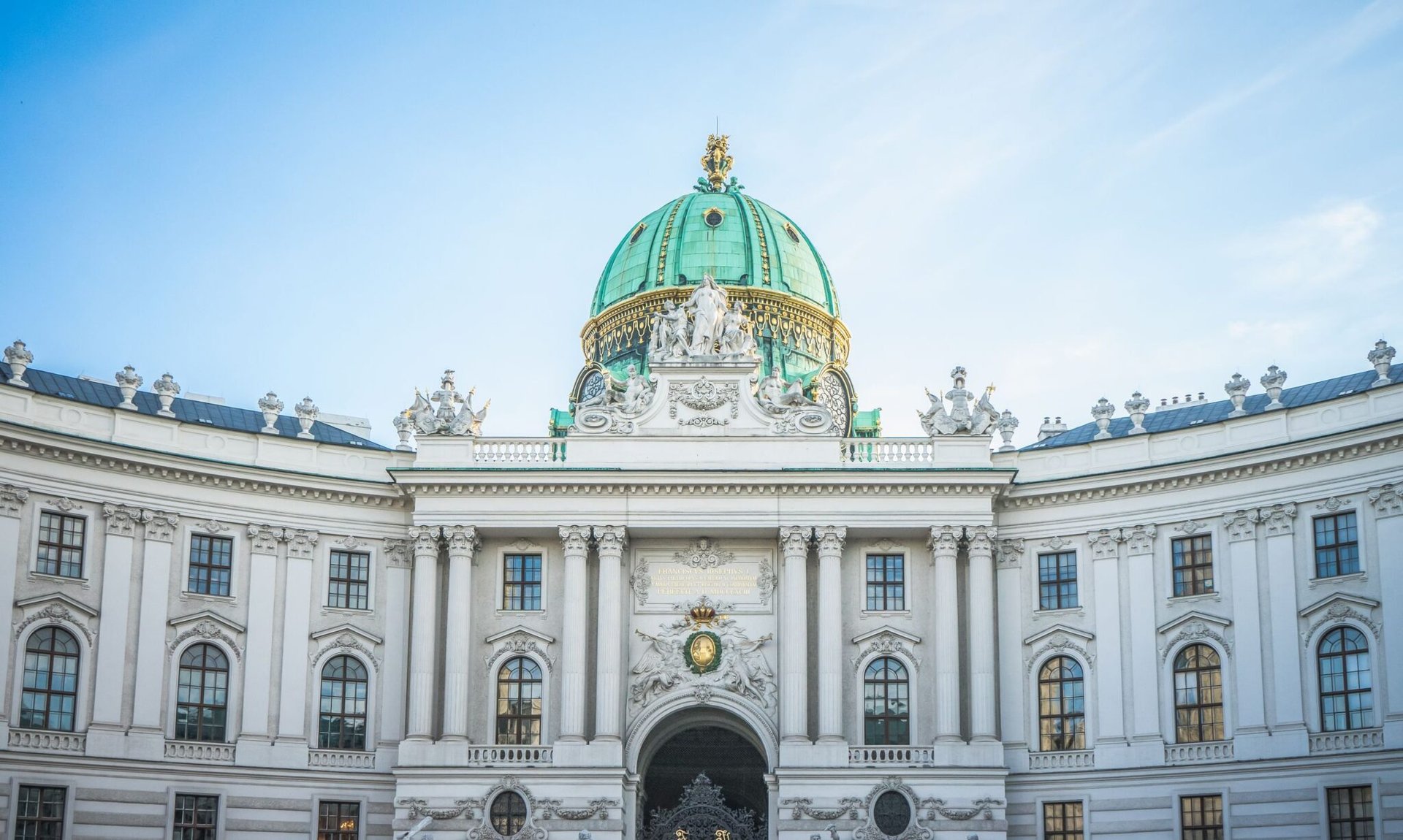 Front view of the majestic Hofburg Palace exterior in Vienna, Austria showcasing its grand architecture.