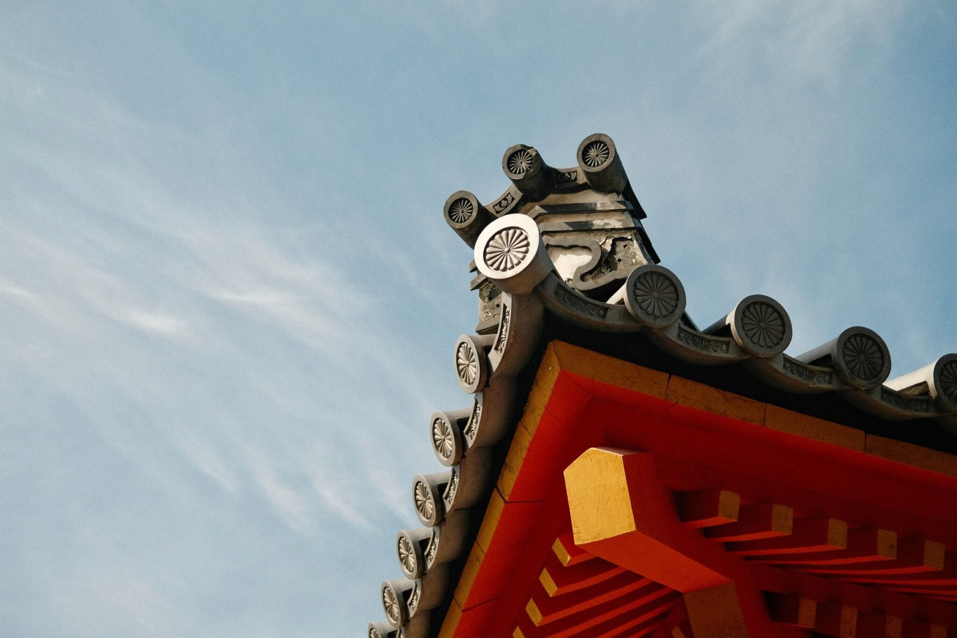 Detailed view of a traditional Japanese temple roof in Kyoto with decorative elements.