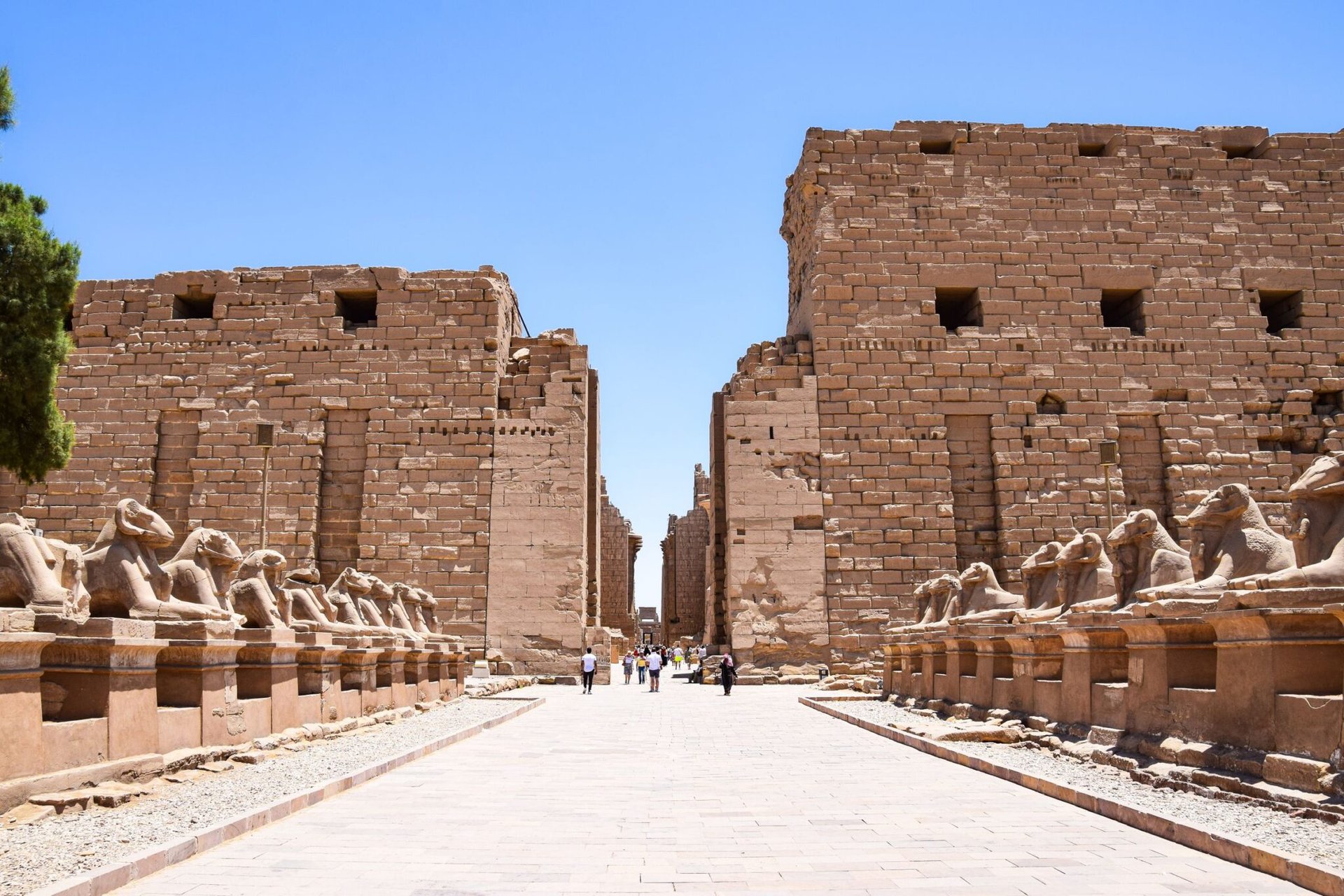 Karnak Temple's ancient ruins under a bright blue sky in Luxor, Egypt.