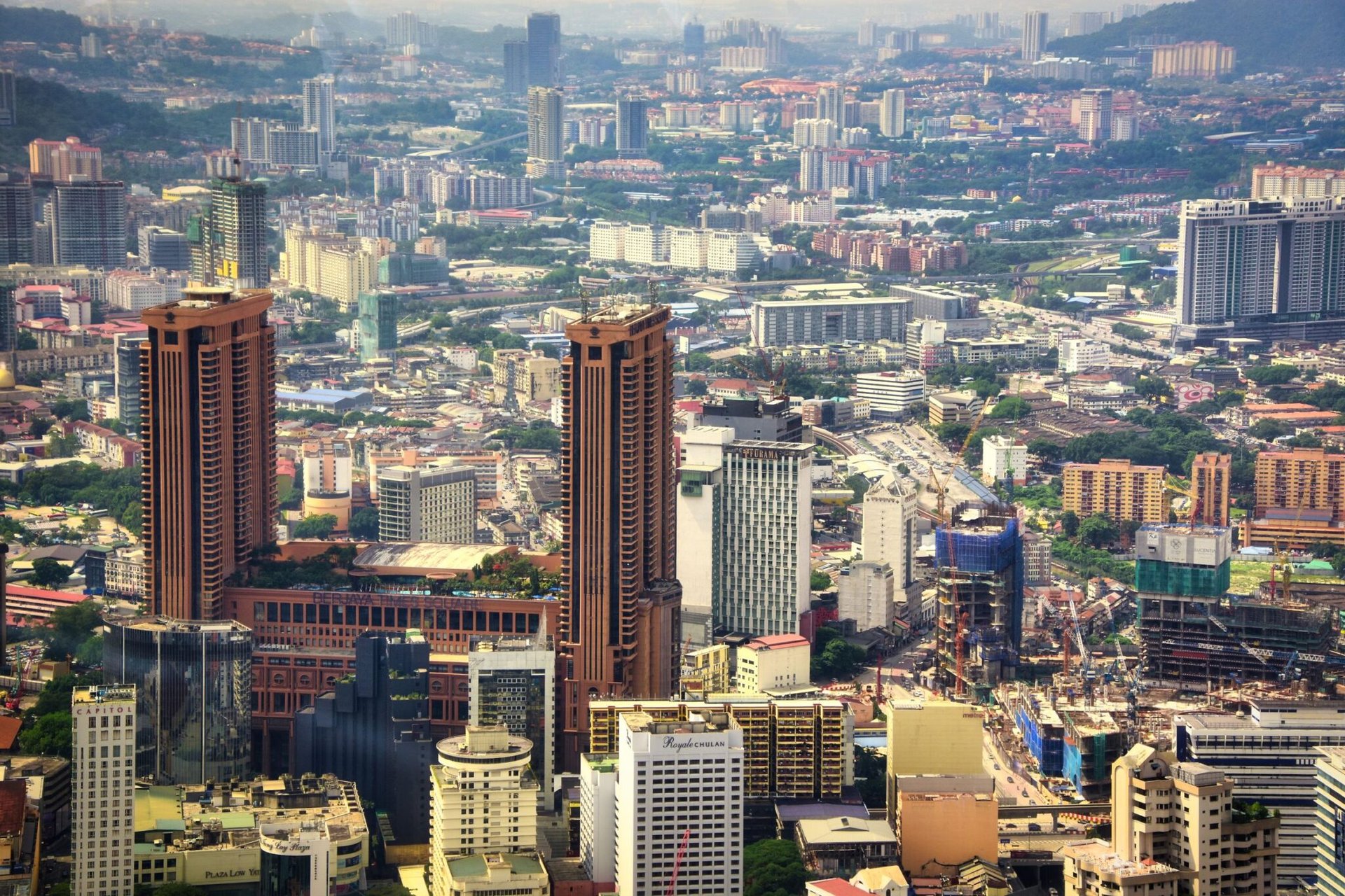 Stunning aerial view of bustling Kuala Lumpur showcasing iconic skyscrapers and urban landscape.