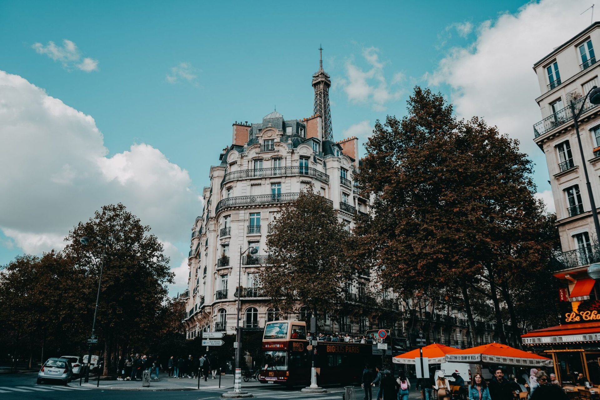 Charming urban street scene in Paris with classic architecture and the Eiffel Tower.
