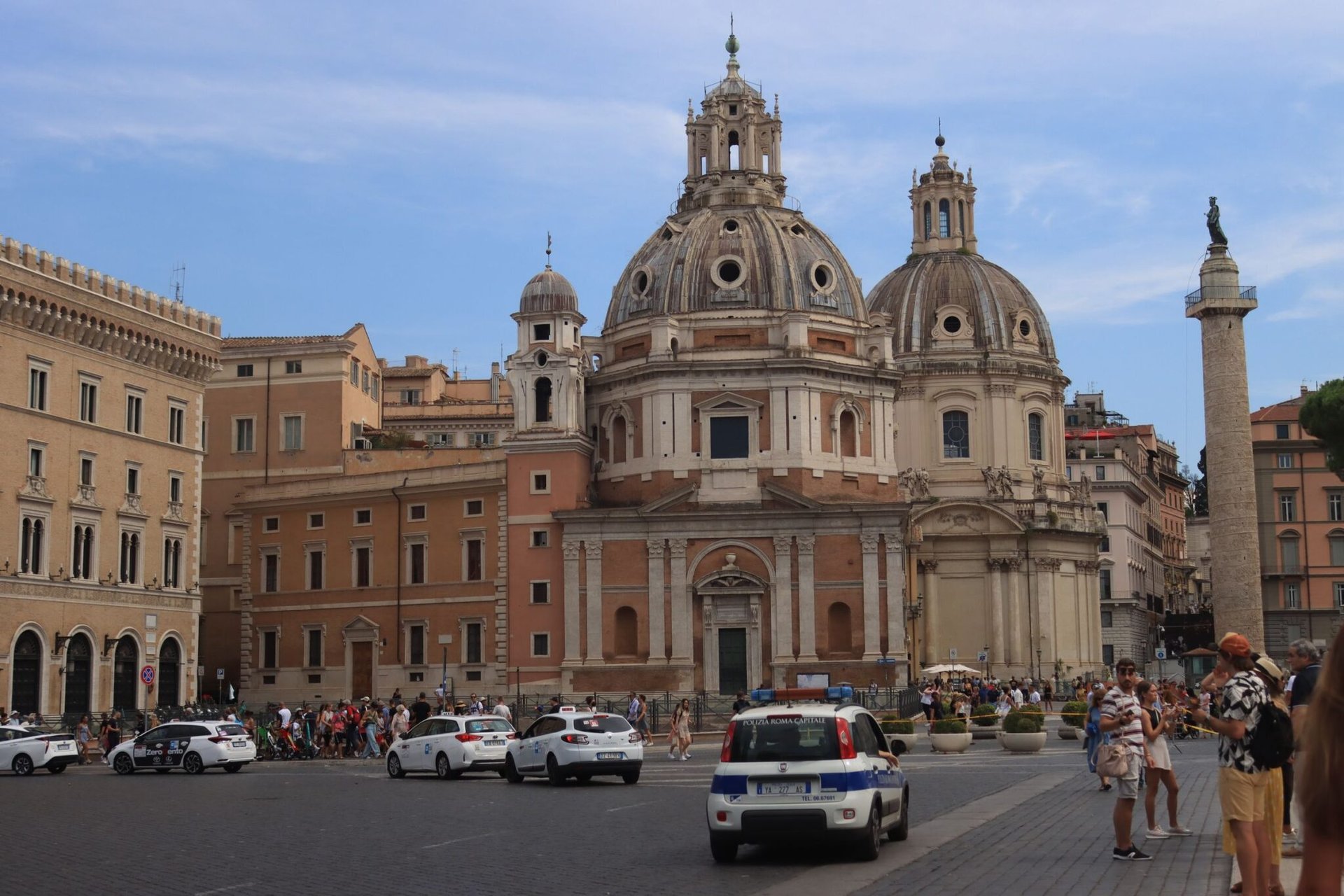 Historic architecture and lively city square with Trajan's Column in Rome, Italy.