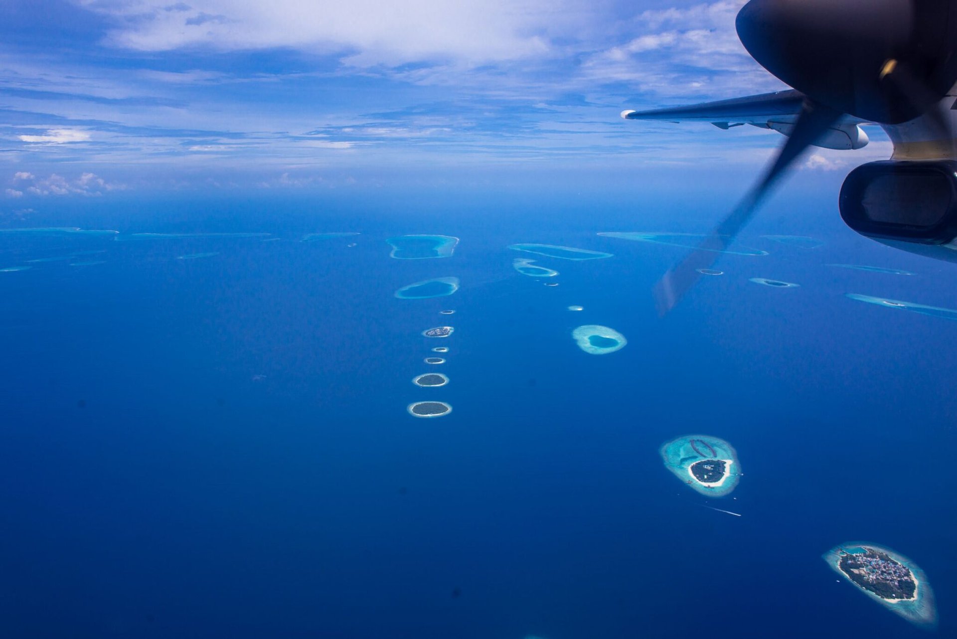 Stunning aerial seaplane view of Maldives atolls over the ocean.