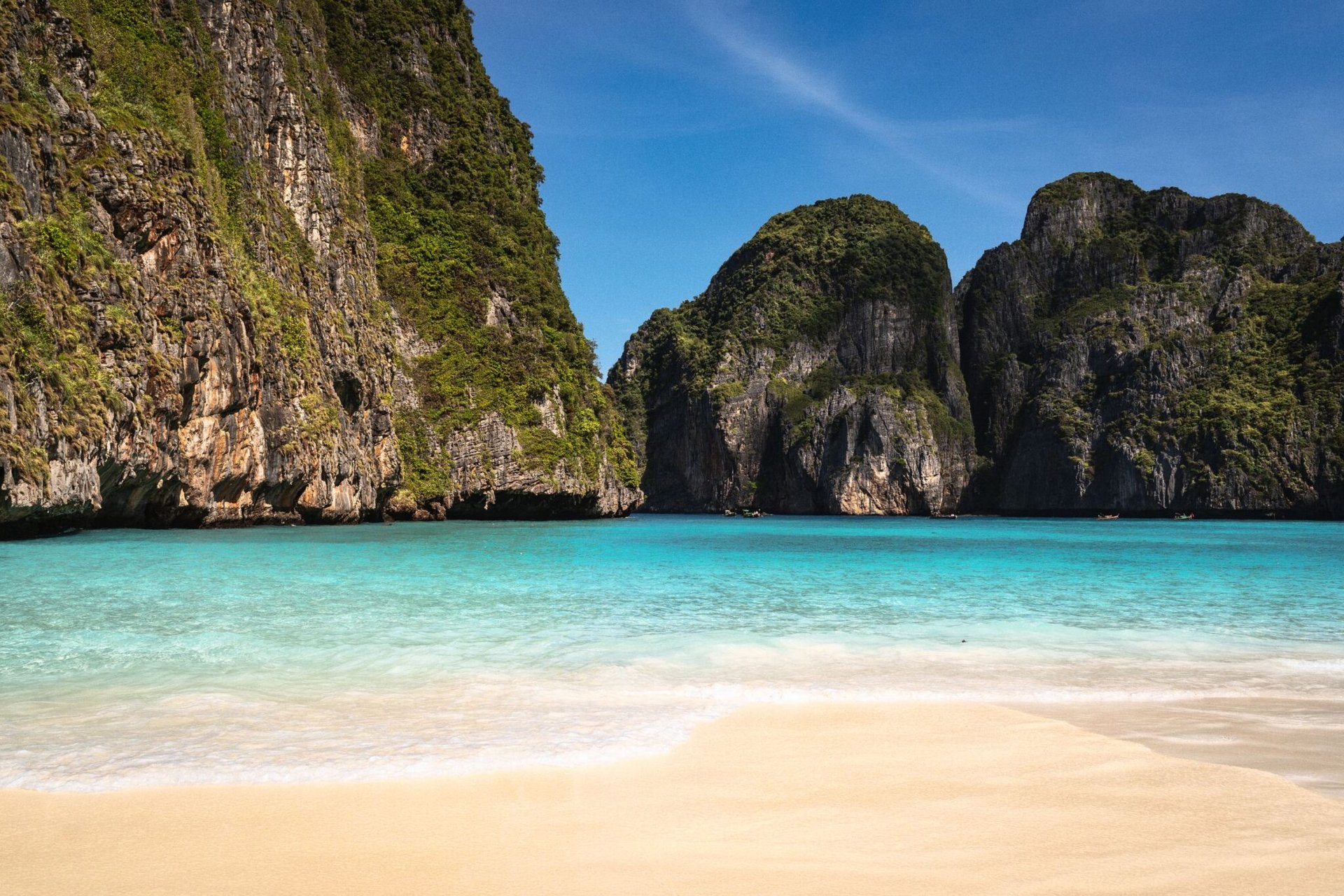 Turquoise waters and limestone cliffs in Krabi, Thailand offer a breathtaking beach view.