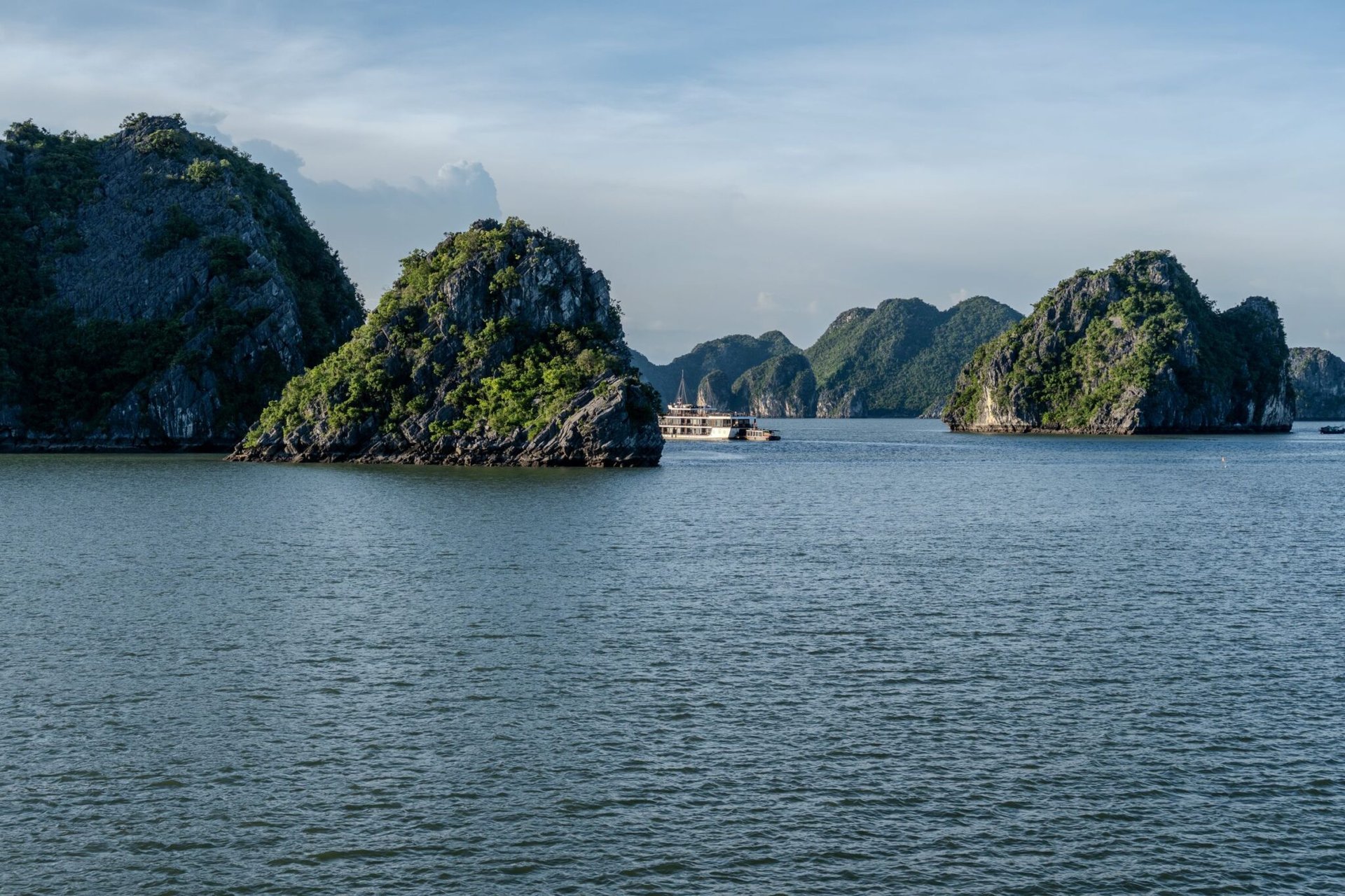 Beautiful limestone islands in Ha Long Bay, Vietnam, captured on a sunny day.