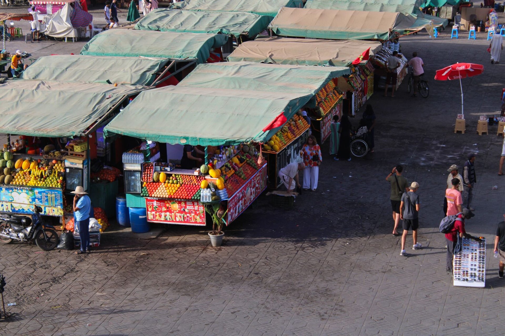 Colorful Moroccan souk stalls in Marrakech bustling with local vendors and fresh produce.