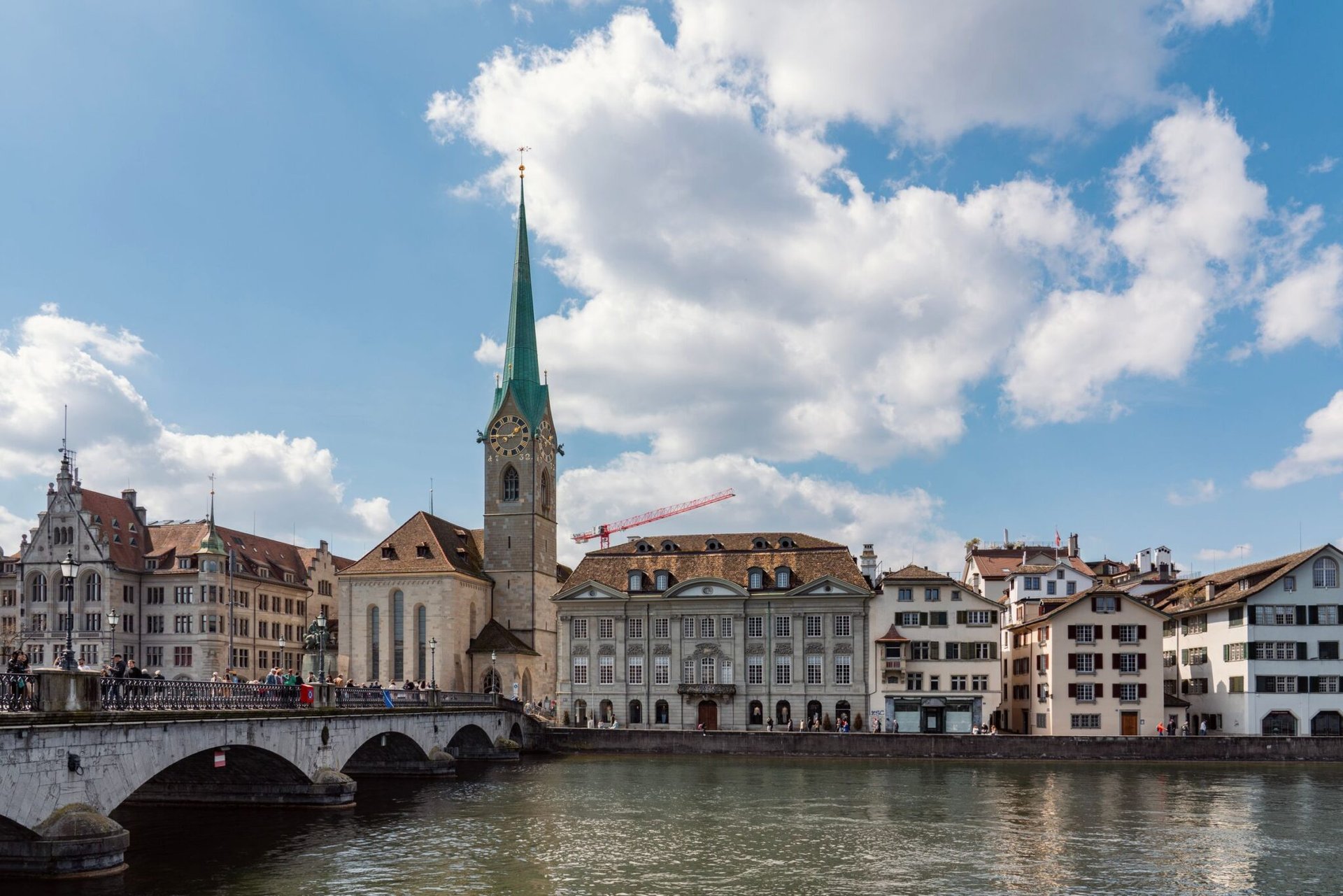 Panoramic view of Fraumünster Church and historic buildings along the water in Zurich, Switzerland.